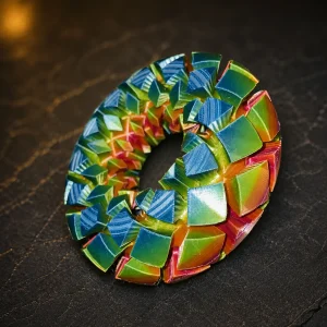 Multicolor 3-inch Rodin coil on a dark studio surface